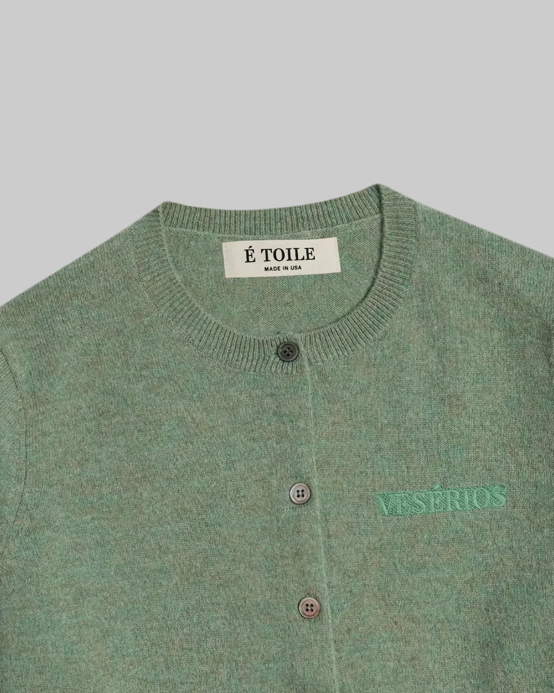 Sage green wool cashmere cardigan with VESÉRIOS embroidery detail